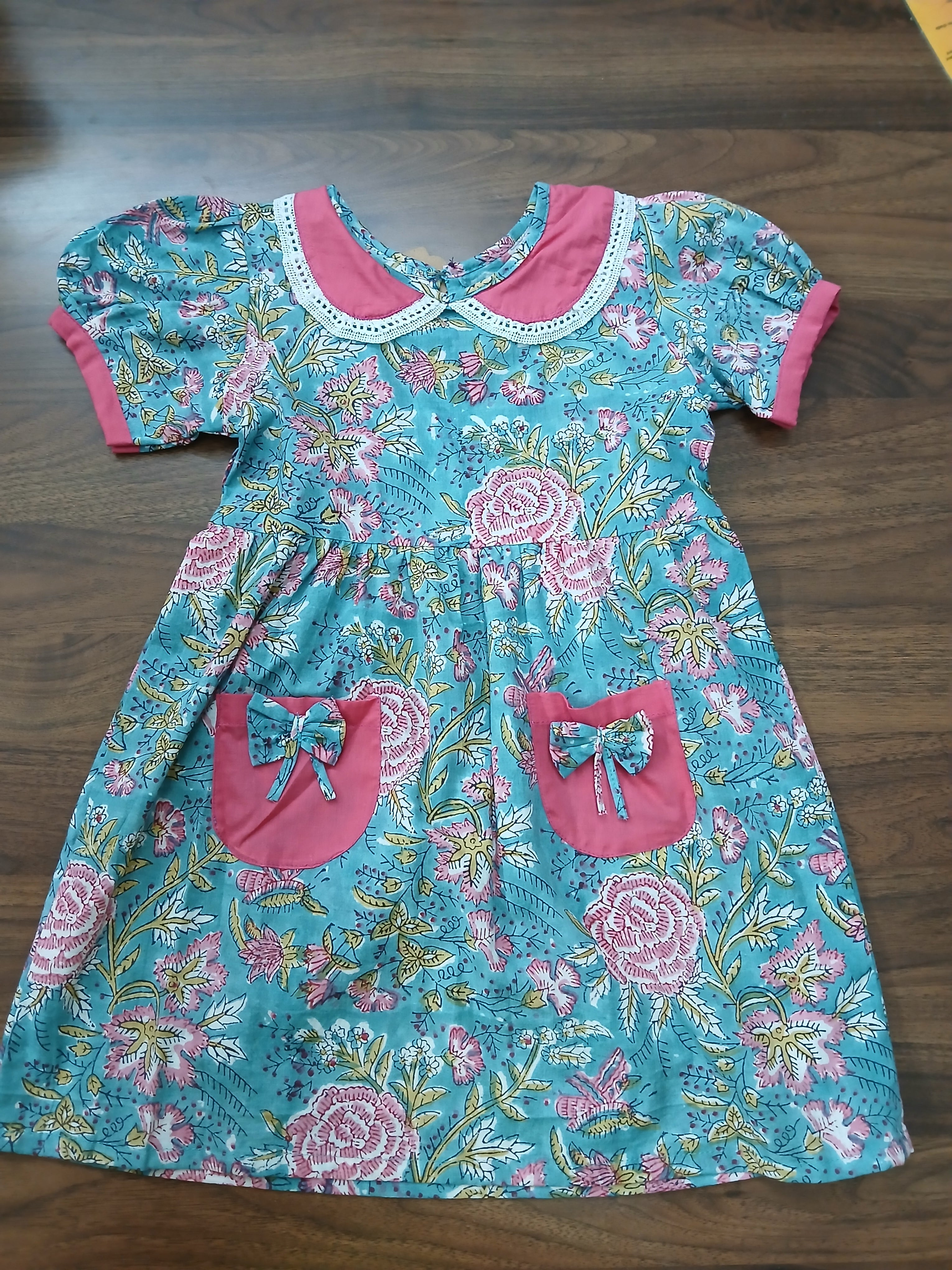 Girl dress in turquoise and pink hand block print floral cotton with Peter Pan collar and bow pockets